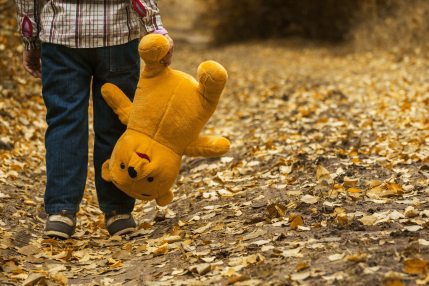 boy-carrying-bear-plush-toy-33159